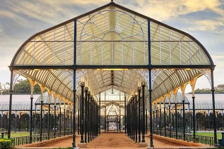An ornate glasshouse structure with detailed metal framework and pillars