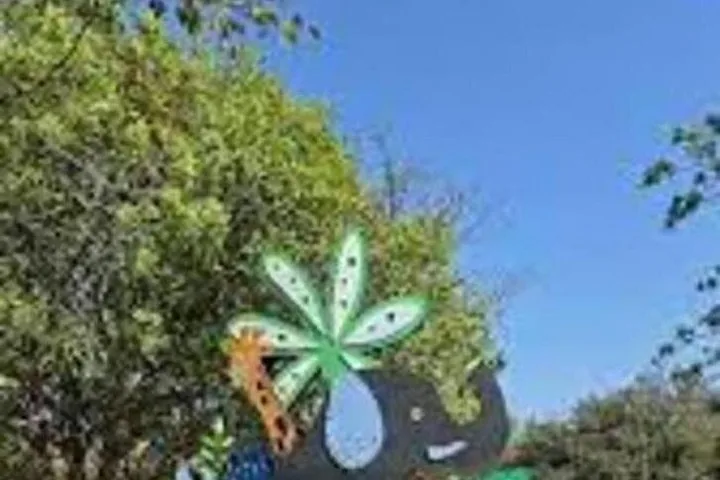 Decorative elephant and flower figures in a park setting